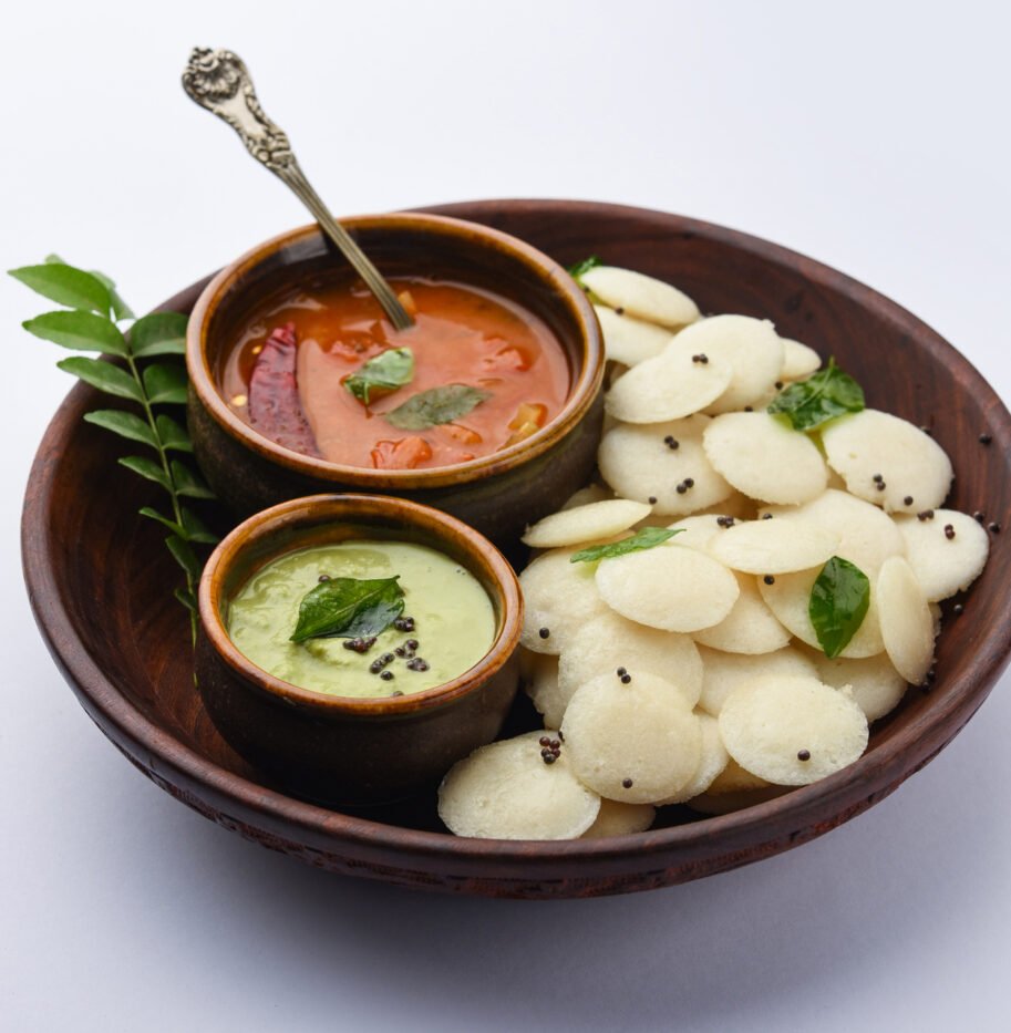 Mini idli is the smaller version of soft and spongy round shaped steamed regular rice idli, also known as button and cocktail idly